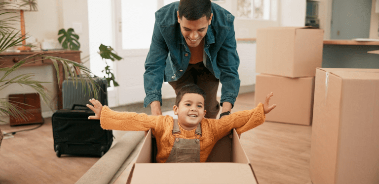 Parent and child playing with a moving box